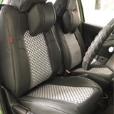 A set of black faux leather car seat covers with red stitching, including a front seat cover, rear seat covers, and a headrest pillow.